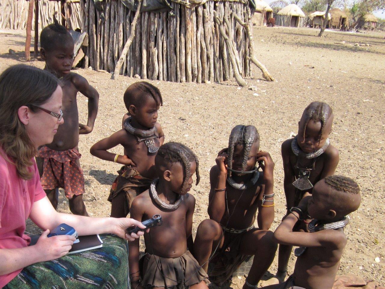 Linda playing recorded Bible stories for Himba children near Opuwo in no...